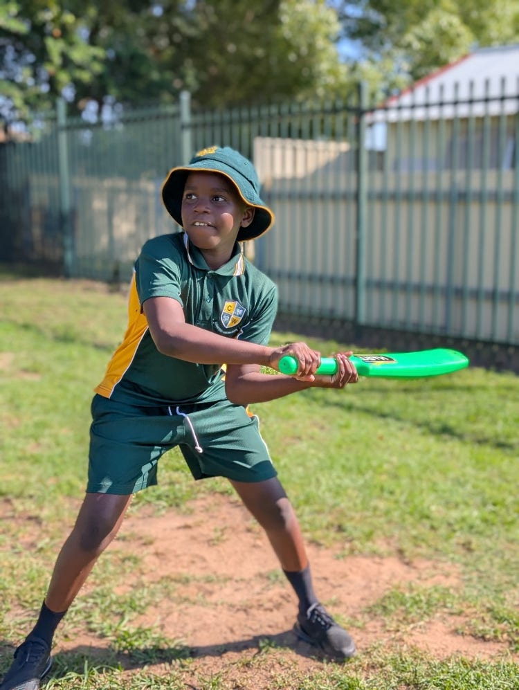 student playing cricket