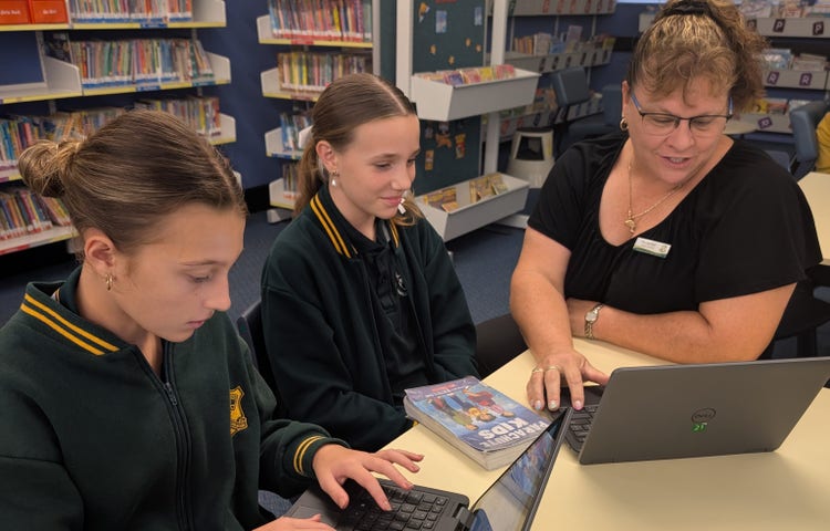 librarian using computer with students